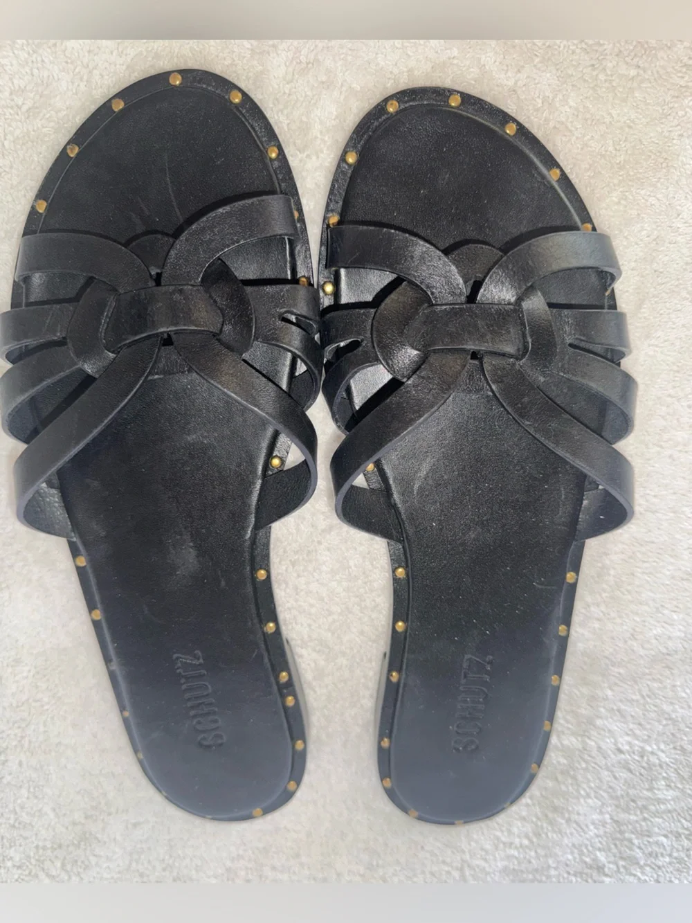 Schutz Phoenix flat sandals delicate woven straps n metallic stud along midsole.